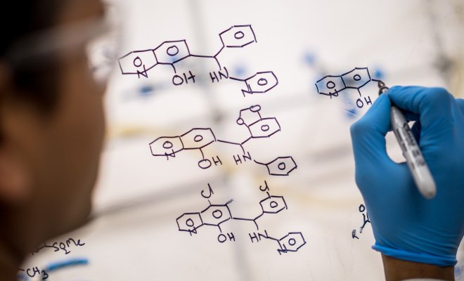 Scientist drawing up a molecular structure.