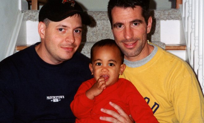 Peter Mercurio and Danny Stewart pose on stairwell with Kevin for family photo