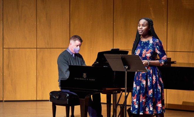 A female student sings while male pianist accompanies.