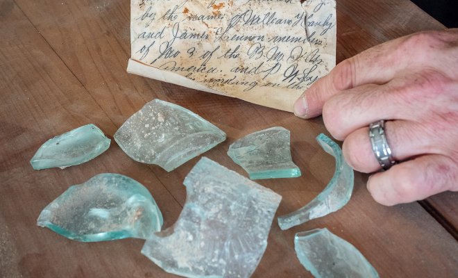 Letter from a glass bottle broken open.