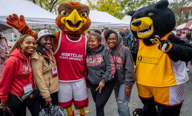 Mascots, Rocky and Deacon, taking a picture with students.