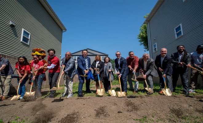 Group of people breaking ground on a new house