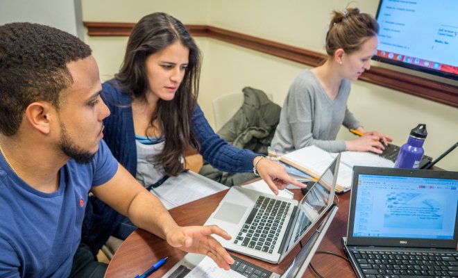 Students working together on laptop