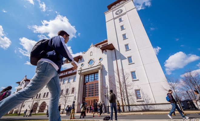 student in front of University Hall