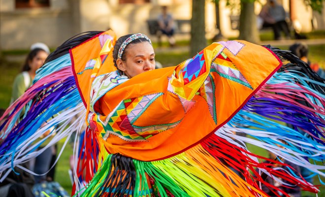 Native American dancer in colorful traditional regalia