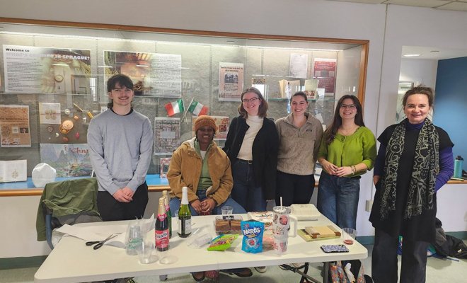 students standing in from of cookbook display