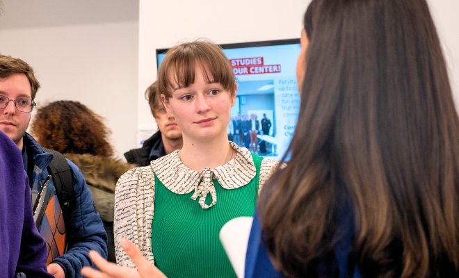Students speaking to recruiter at a career fair event.
