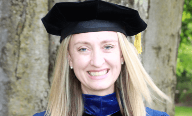 Photo of Alexandra Thelin Blackowski in graduation robe from Drew University