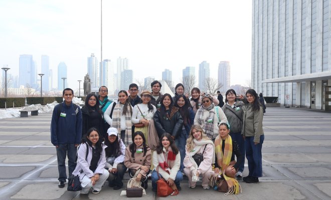 Group of students with NYC skyline behind them
