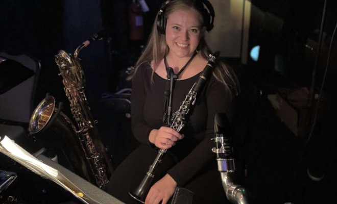 Maria Vincelette with clarinet in orchestra pit