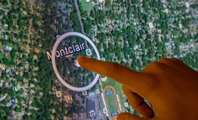 Digital map with finger pointing to Montclair