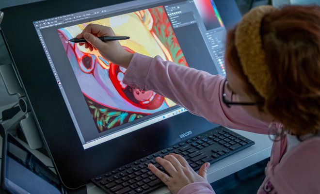 Student working on a digital painting on their laptop with stylus