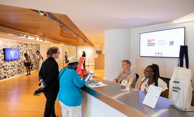 University Galleries front reception desk with visitors asking questions to the staff
