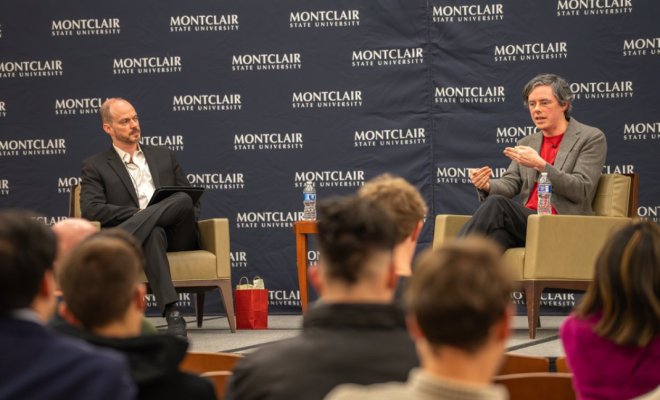 Jack Hanlon on stage being interviewed by Michael Hacker