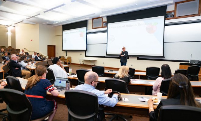 man presenting powerpoint to audience