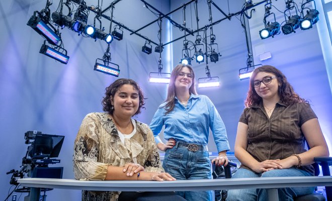 News Lab producers pose by the anchor desk.