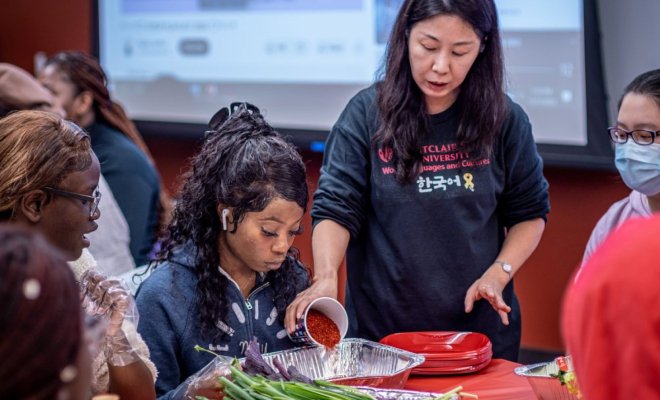 Korean Professor Yun Kim demonstrates how to make kimchi to students, faculty and staff at the workshop