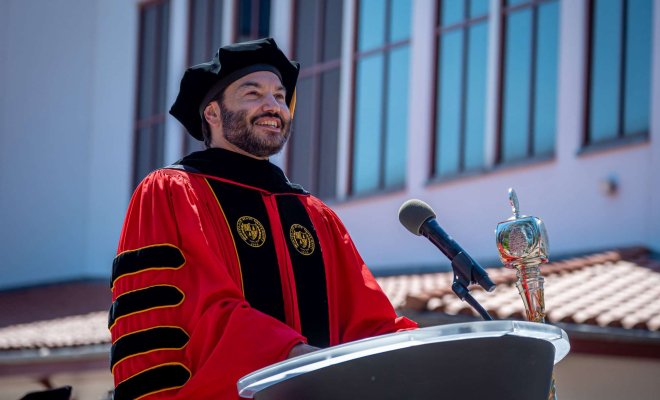 President Koppell at podium in investiture robes and regalia 
