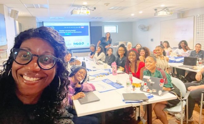 Dr. Michelle Burton selfie in classroom with visiting speaker Salerno