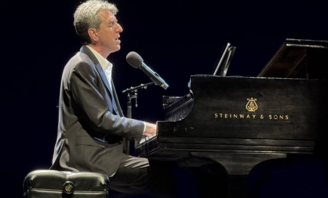 Jason Robert Brown playing the piano on the stage at Kasser Theater