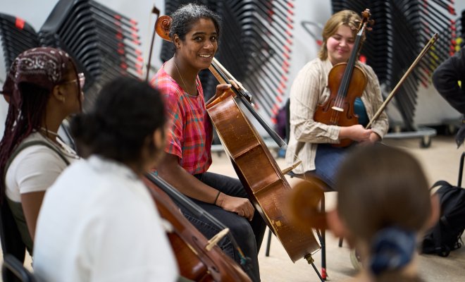 Leyla McCalla with cello and string students