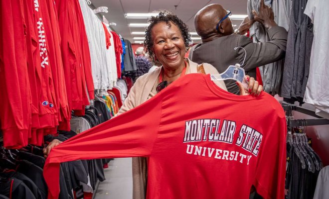 alumni holding up a reunion t-shirt