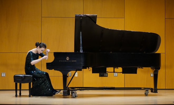 Piano student on stage performing