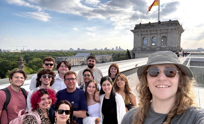 A group of college students posing for a selfie atop a German building