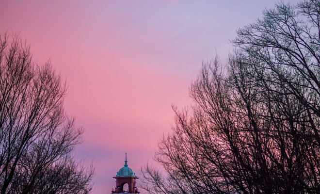 Cole Hall bell tower at sunset on wintry night