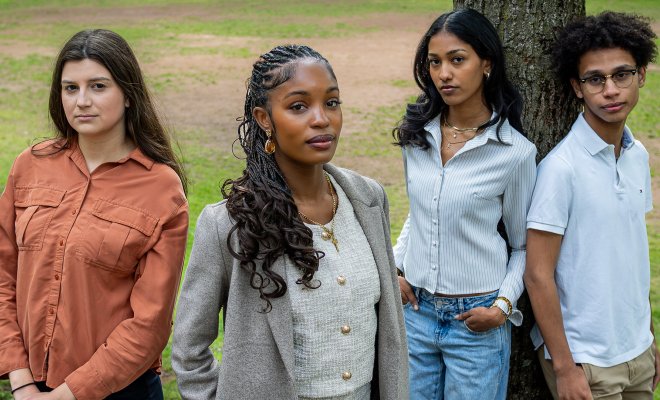 SGA President Leila Jones, stands in foreground, with executive board members, from left, Carmela Beitler, Edlyn Eugene and Danny Gonzalez. Edlyn and Danny are leaning against a tree.