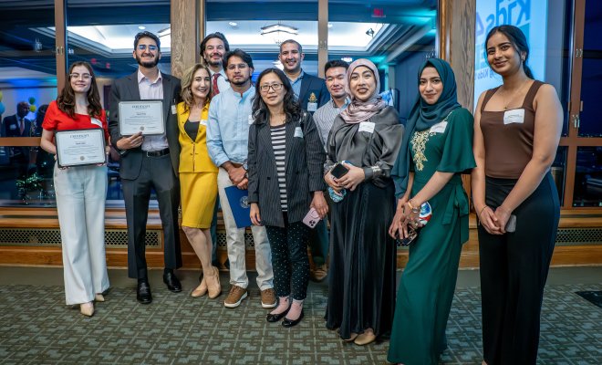 Group of students and professors posing at an event