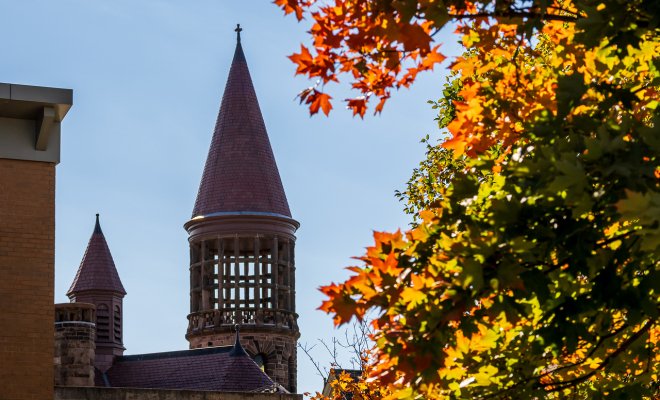 A building tower with fall leaves 