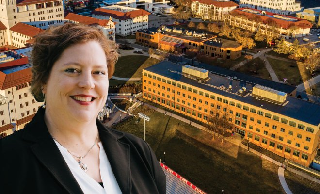 Amy Thompson posing with a photoshopped building behind her.
