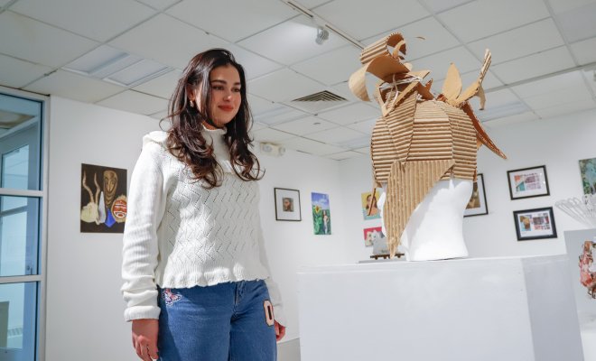 Student looking at artwork in the Finley Gallery