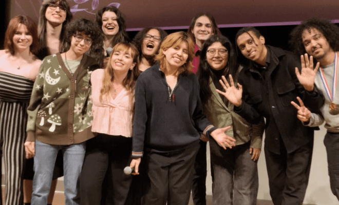 Group of students on stage posing for a photo.
