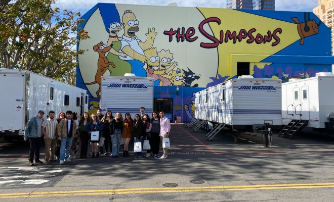 Students posing in front of The Simpsons studio in LA.