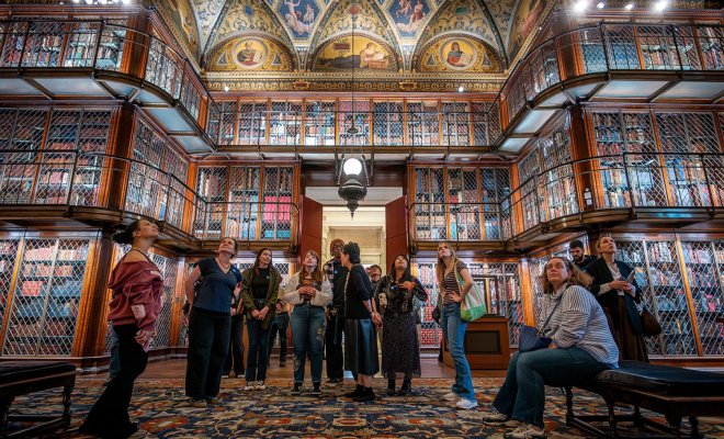 A group of college students stand in the middle of the Morgan Library in New York City