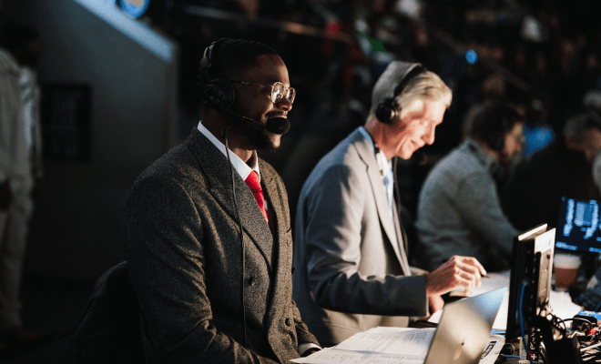 Side view of Edmond commentating his first NBA game.