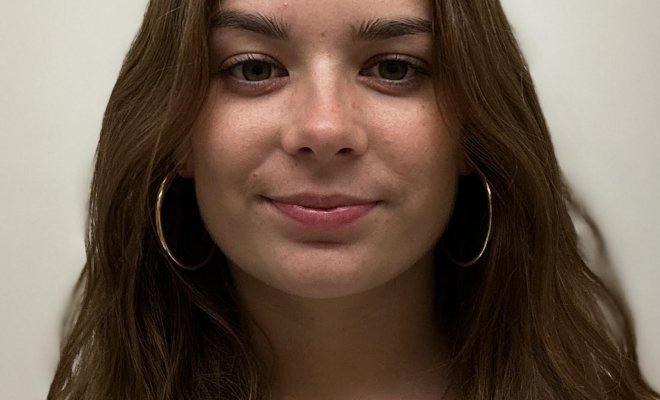 Student headshot against white wall.