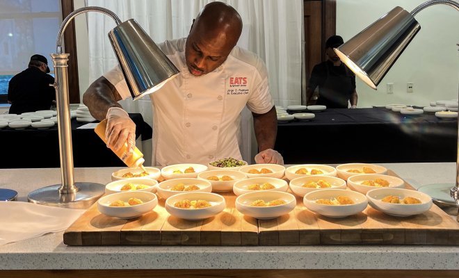a chef infront of a food catering station