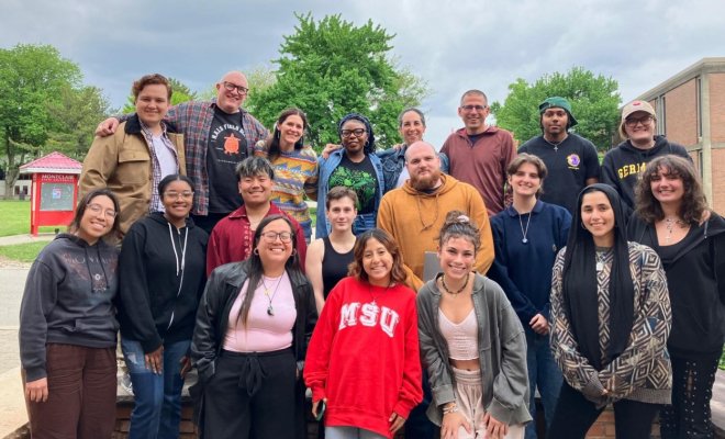 a group of people pose together on the campus of Montclair State University
