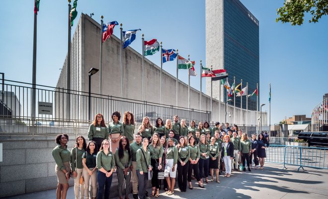Green Team group photo at the United Nations under line of country flags