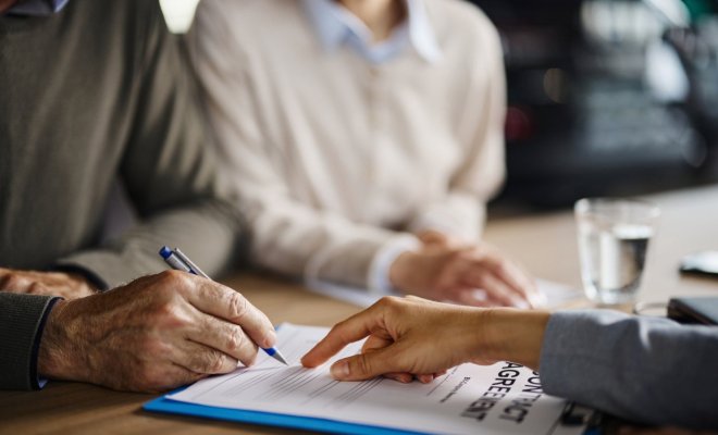 Image of perrson signing an agreement