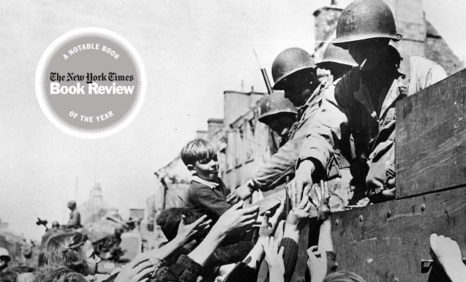 A black and white image of WW2 soldiers passing out food from a truck to children 