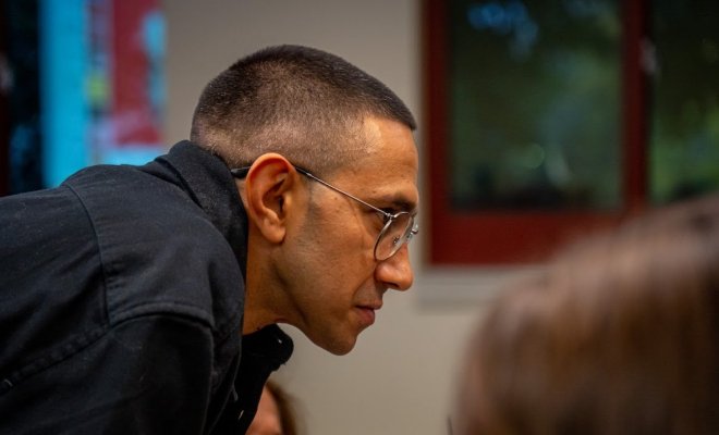 A side view of a man leaning forward