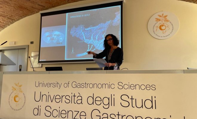 Dr. Teresa Fiore delivers a lecture to an audience