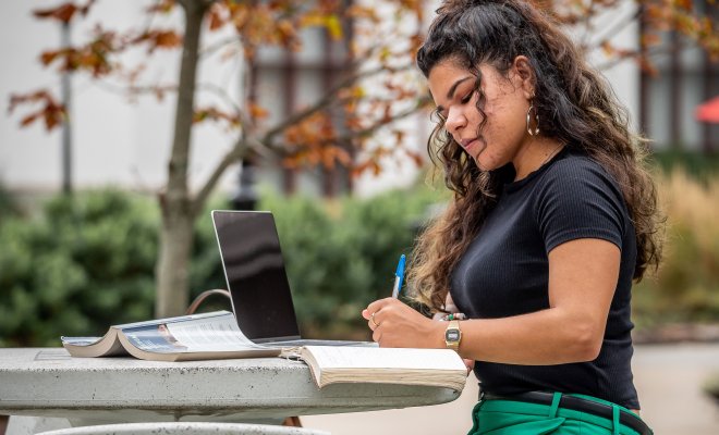 Student studying outside on laptop