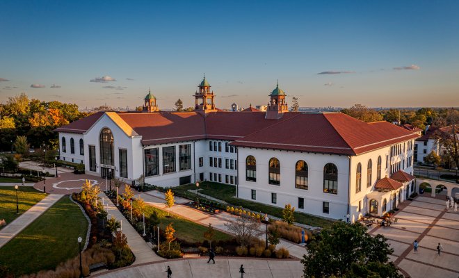 Aerial photo of Cole Hall and students walking.