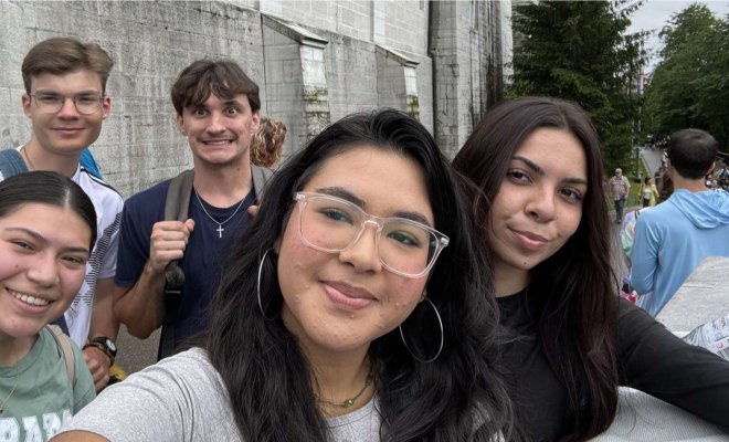 A group of five college students take a selfie outside a castle in Munich, Germany