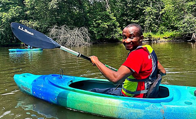 Odera Umeh in a canoe on a lake